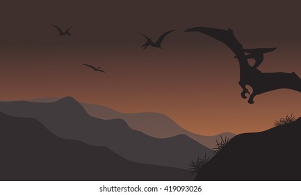 Silhouette of pterodactyl fly at the night with brown backgrounds