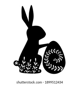 Silhouette of rabbit with egg. Easter Bunnies.  Silhouette of a rabbit with flower pattern. Vector illustration isolated on a white background.