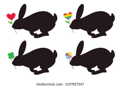 Silhouette of the rabbit with a heart flower and clover