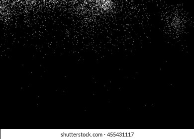 Silhouette of salt flakes spread on the flat surface or table. Top view of dust, sand blow. Abstract grainy texture isolated on black background.