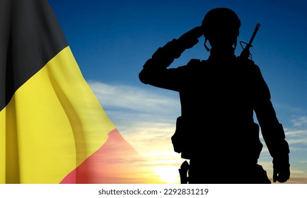 Silhouette of a saluting soldier against the sunset with Belgium flag. EPS10 vector