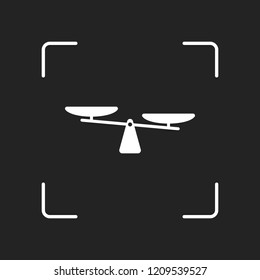 silhouette of scale, simple symbol. White object in camera autofocus on dark background