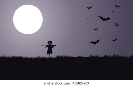 Silhouette of scarecrow and bat Halloween with full moon