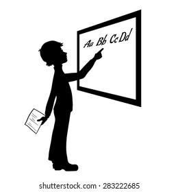 Silhouette of schoolboy at blackboard