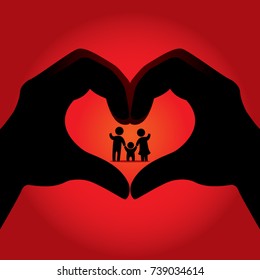 Silhouette Shadow of Two Hands Creating a Heart Shape Image with Family as the Focus