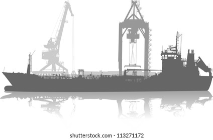 silhouette of ship in port on unloading under the crane