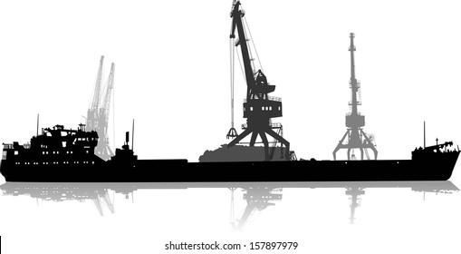 Silhouette of ship in port on unloading under the crane