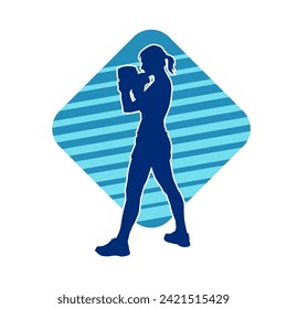 Silhouette of a slim female doing martial art pose. Silhouette of a martial art woman in action pose.