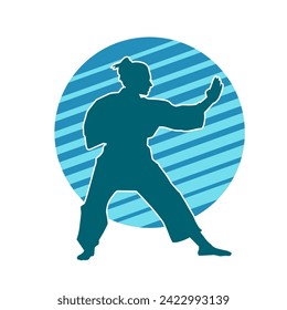 Silhouette of a slim female doing martial art pose. Silhouette of a martial art woman in action pose.