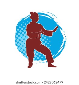 Silhouette of a slim female doing martial art pose. Silhouette of a martial art woman in action pose.