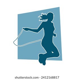 Silhouette of a slim sporty woman doing jump rope workout.