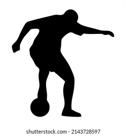 silhouette of soccer player dribbling the ball