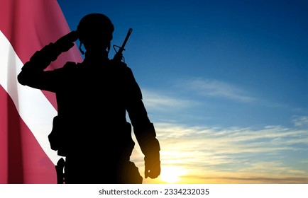 Silhouette of a soldier with Latvia flag on sky. EPS10 vector