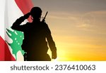 Silhouette of a soldier with Lebanon flag against the sunset. EPS10 vector