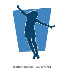 Silhouette of a sporty female doing aerobics or gymnastic action pose. Silhouette of a woman in gym doing acrobatic pose.