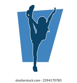 Silhouette of a sporty female doing aerobics or gymnastic action pose. Silhouette of a woman in gym doing acrobatic pose.