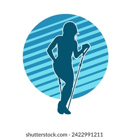 Silhouette of a sporty woman at gym workout using pull rope. Fitness exercise cords pull rope stretch resistance training.