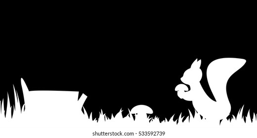 Silhouette of the squirrel in the grass.