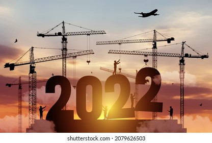 Silhouette staff works as a to prepare to welcome the new year 2022. Large construction site, many construction cranes set numbers 2022. Construction team sets numbers for New Year 2022. Vector.