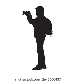 Silhouette of Standing Photographer with Backpack Holding Camera