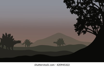 Silhouette of stegosaurus in fields with fog