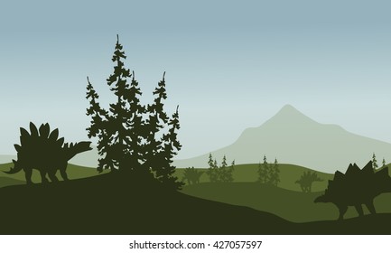 Silhouette of stegosaurus in green fields at morning