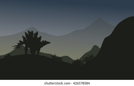 Silhouette of stegosaurus in hills at the night