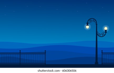 Silhouette of street lamp and fence scenery