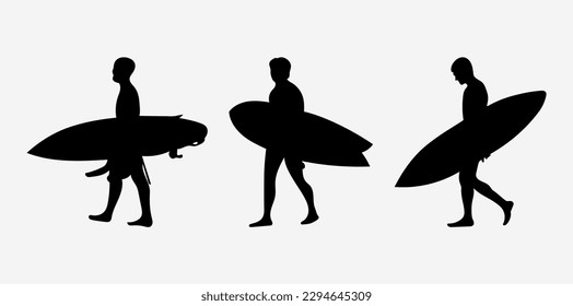 The silhouette of surfers with their boards.