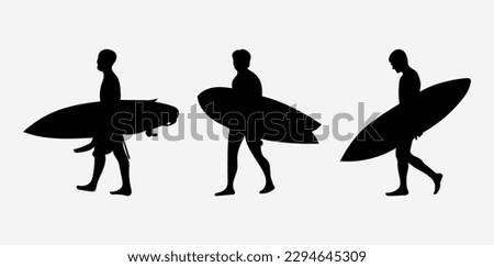 The silhouette of surfers with their boards.