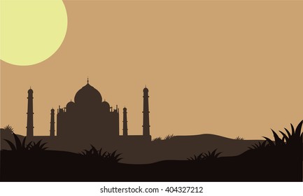 Silhouette of Taj Mahal in the fields and moon