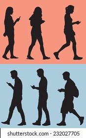 Silhouette Of Teens Texting While They Walk