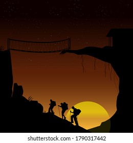 A Silhouette Of Three Mountain Climbers With A Dramatic Sky Background