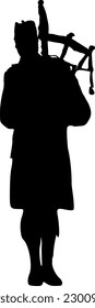 Silhouette: traditional bagpiper from the front