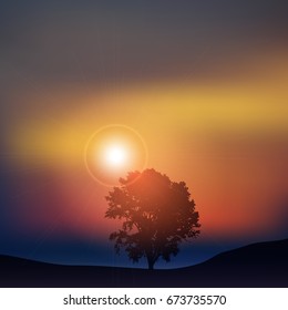 Silhouette of a tree against a sunset sky