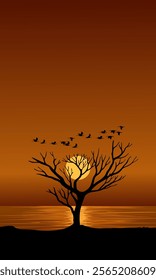 Silhouette of a tree and flying birds over the lake at sunset