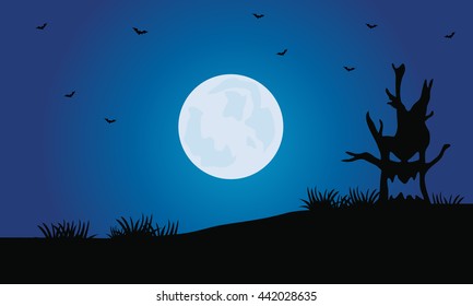 Silhouette of tree monster and full moon Halloween scenery