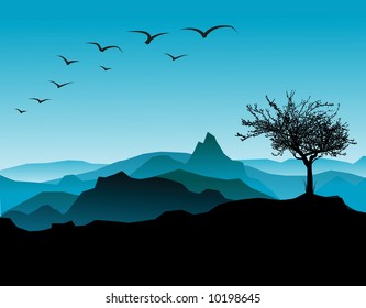 Silhouette of the tree, with mountains in the background