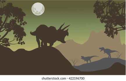 Silhouette of triceratops and baby T-Rex at the night