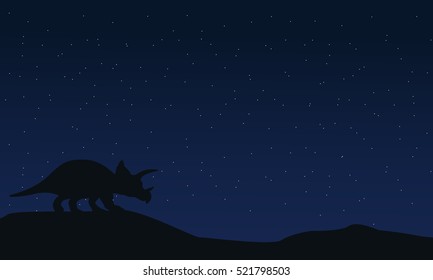 Silhouette of triceratops at night landscape
