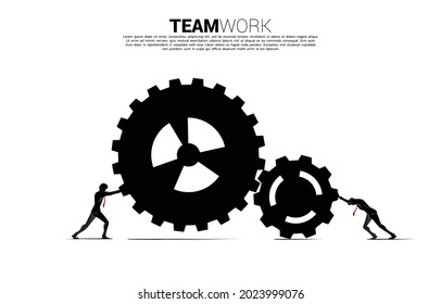 Silhouette of two businessman pushing the gears to work. concept of business teamwork.