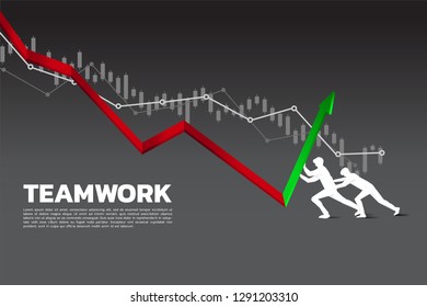 Silhouette of two businessman pushing the graph to up direction.stop financial crisis . concept of business challenge and teamwork.