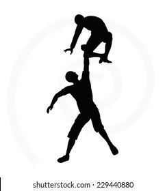 silhouette of two senior climbers men team holding on with a helping hand