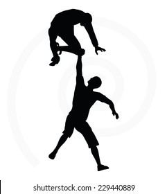 silhouette of two senior climbers men team holding on with a helping hand