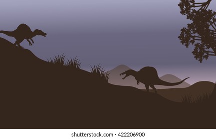 Silhouette of two spinosaurus in fields at the night