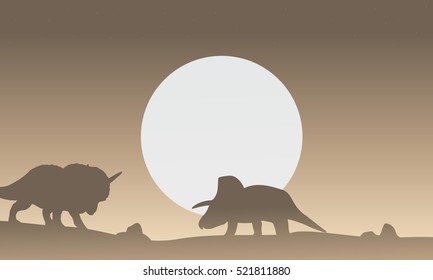 Silhouette of two triceratops dinosaur scenery