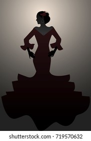 Silhouette of typical Spanish woman wearing flamenco dress. 