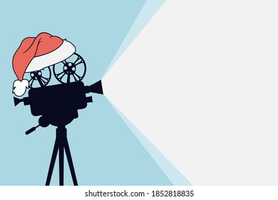 Silhouette of vintage cinema projector on a tripod with Santa Claus hat. Cinema background. Film camera projecting a beam of light with place for text. Movie festival template for banner, flyer,poster