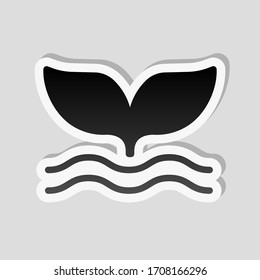 Silhouette of whale tail on wave. Sticker style with white border and simple shadow on gray background