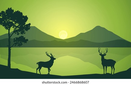 Silhouette of wild deer with trees on the edge of the lake and beautiful mountains in the morning,evening, sunset,sunrise